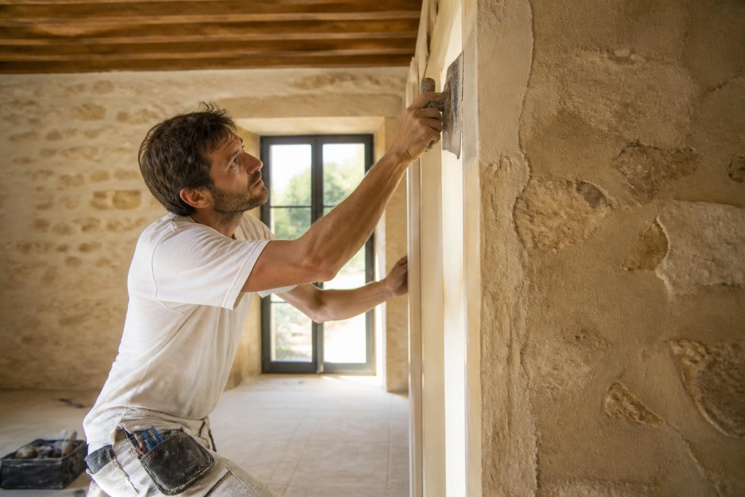 Craftsman renovating a natural stone wall in a Mallorca finca